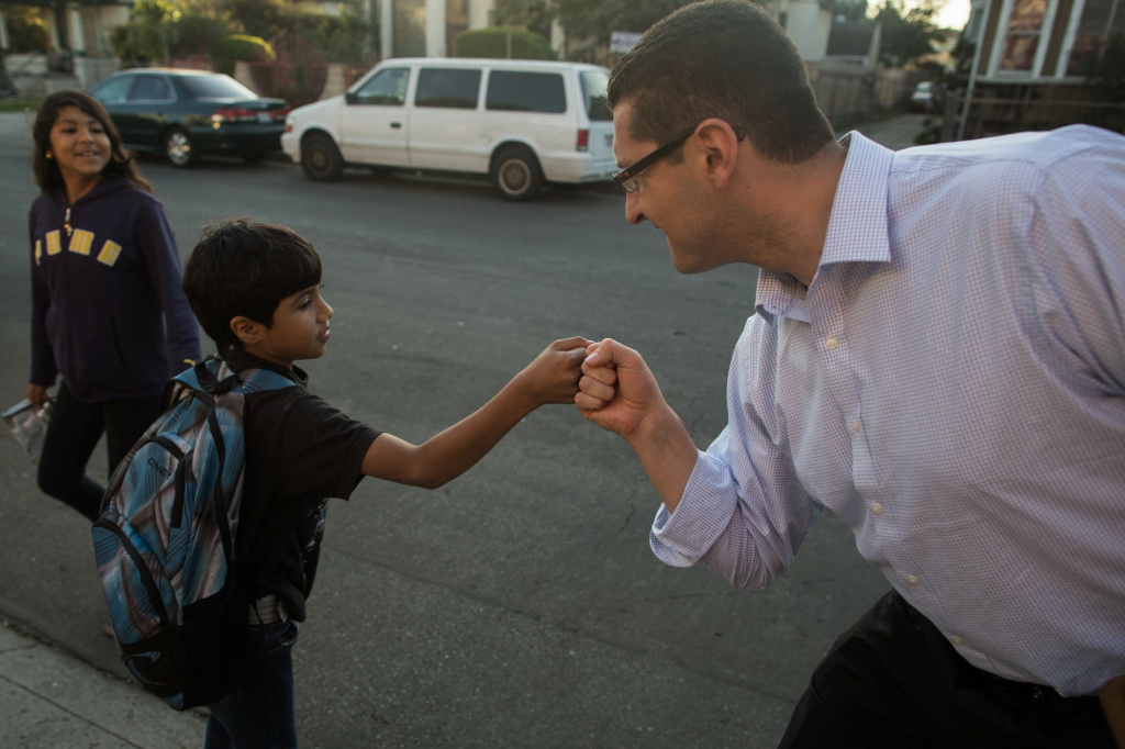 Emanuel Pleitez Profile Mayoral candidate Emanuel Pleitez fist bumps with a Sabaq. Pleitez has focussed on canvassing poorer, Latino neighborhoods since his campaign started in July.