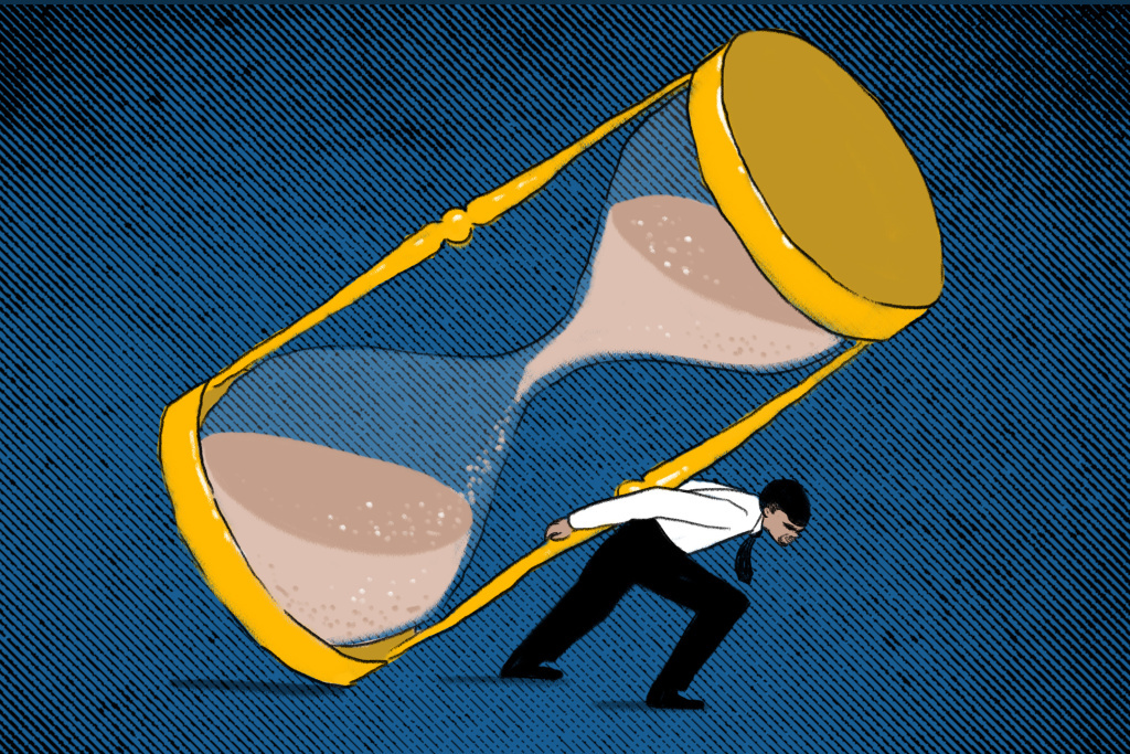 Businessman holding hourglass on his back