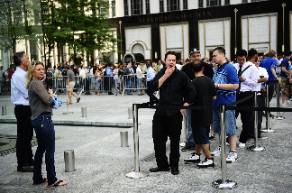 Apple fans wait in line to become the first owners of the latest-generation iPhone, called the iPhone4, as it made its global debut in five countries, June 24, 2010 in New York.
