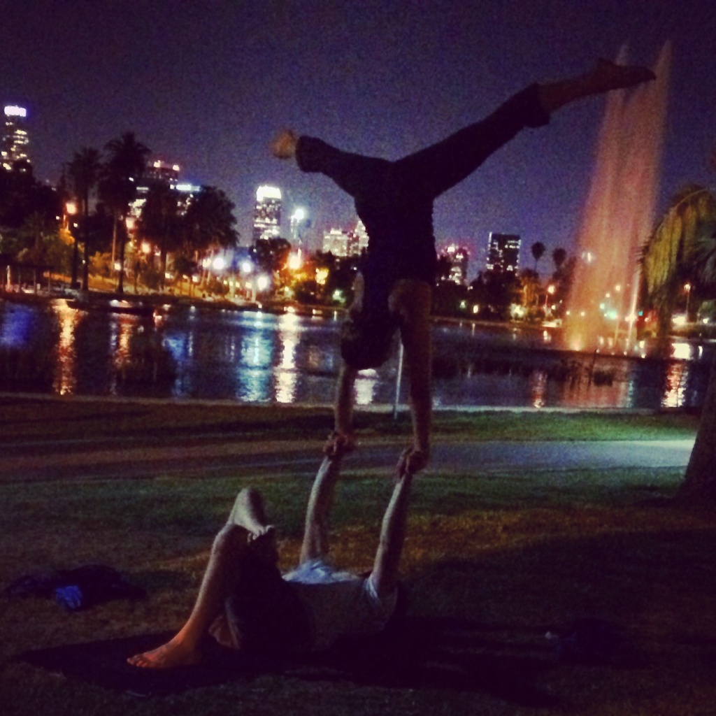 KPCC's Rebecca Plevin performs acro-yoga.