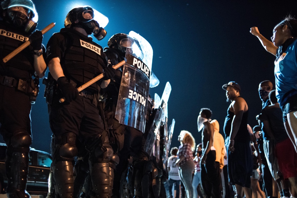 Protests Break Out In Charlotte After Police Shooting CHARLOTTE, NC - SEPTEMBER 21: Police officers face off with protesters on the I-85 (Interstate 85)during protests in the early hours of September 21, 2016 in Charlotte, North Carolina. The protests began last night, following the fatal shooting of 43-year-old Keith Lamont Scott by a police officer at an apartment complex near UNC Charlotte. (Photo by Sean Rayford/Getty Images)