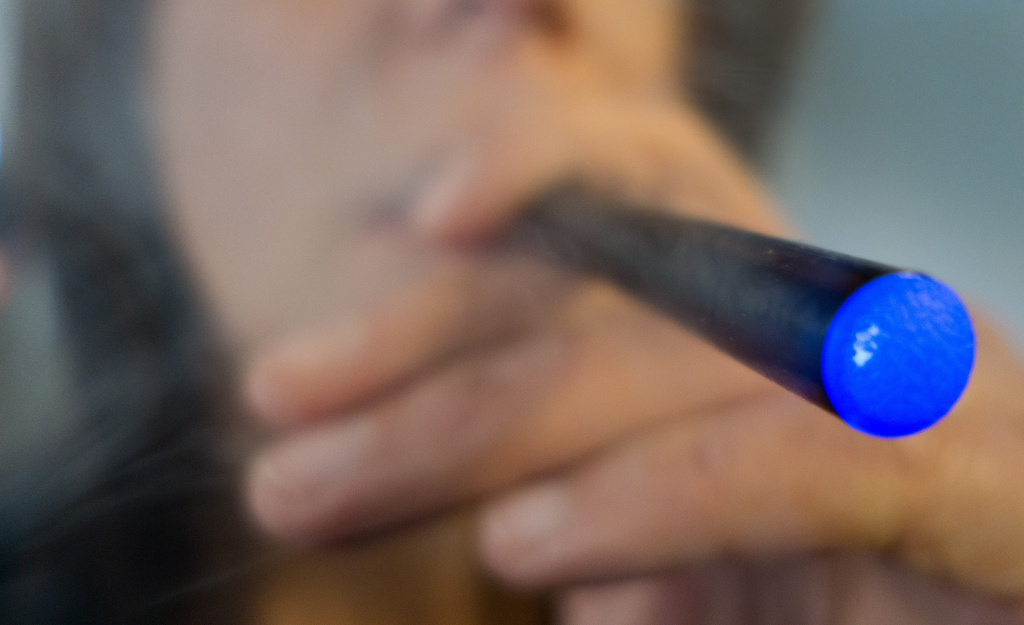 US-HEALTH-TOBACCO-E CIGARETTE This September 25, 2013 photo illustration taken in Washington, DC, shows a woman smoking a 'Blu' e-cigarette (electronical cigarette). The National Association of Attorneys General on September 24, issued a letter urging the US Food and Drug Administration to clamp down on the fast-growing e-cigarette market, saying manufacturers are enticing teenagers to smoke with cartoon characters, television ads and bubble-gum flavors.