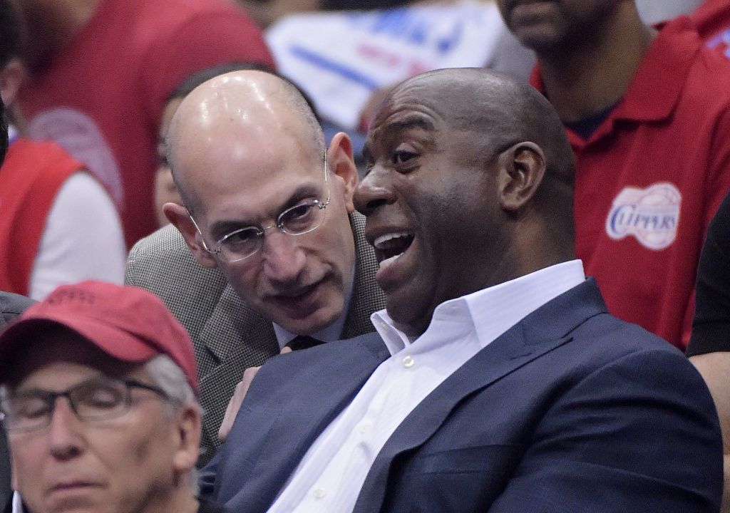 Thunder Clippers Basketball NBA Commissioner Adam Silver, left, talks with Magic Johnson as they watch the Los Angeles Clippers play the Oklahoma City Thunder in the first half of Game 4 of the Western Conference semifinal NBA basketball playoff series, Sunday, May 11, 2014, in Los Angeles. (AP Photo/Mark J. Terrill)