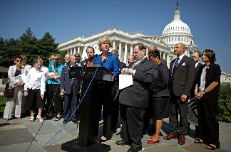 Rep. Tammy Baldwin (D-WI) (C) delivers remarks about legislation to repeal the Defense of Marriage Act during a news conference with other members of Congress and married same-sex couples at the U.S. Captiol September 15, 2009 in Washington, DC.