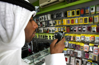 A man looks at a BlackBerry mobile phone in a store in Dubai on August 01, 2010, as the Gulf business hub stated it will suspend key BlackBerry services from October because they are incompatible with local laws and raise security concerns.