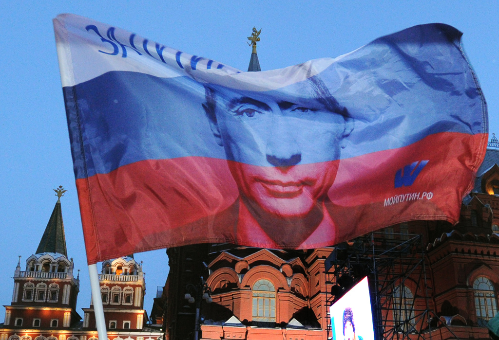 A Russian flag featuring Prime Minister A Russian flag featuring Prime Minister Vladimir Putin flies above his supporters as they celebrate Putin's victory as they rally at the central Manezhnaya Square just outside the Kremlin in Moscow, March 5, 2012.