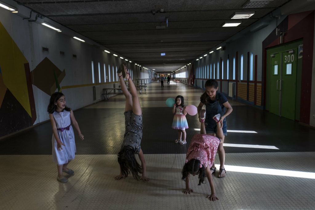 Syrian refugees Syrian refugee girls (from left) Shahd Alamar, 8, Lana Alkhawaja, 9, Maya Alamar, 4, Amal Sakkal, 8, and Hala Alhalaby, 8, play in a hallway at the former prison of Bijlmerbajes in Amsterdam.