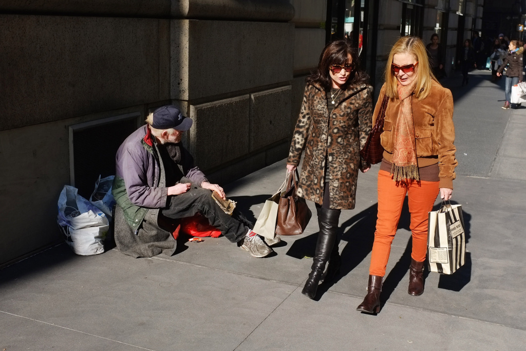 New York City Tops Nation In Income Inequality Women walk by a panhandler along Madison Avenue, one of Manhattan's premier shopping and residential streets on November 1, 2011 in New York City.