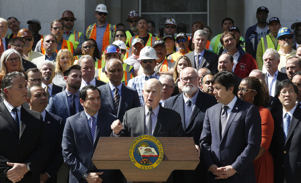 California Road Repairs California Gov. Jerry Brown announces a plan to raise $52 billion to fix California roads during a news conference March 29, 2017, in Sacramento. The 10-year plan would boost the gasoline excise tax by 12 cents a gallon along with higher registration fees and a $100 charge on emission-free vehicles. Brown was flanked by Assembly Speaker Anthony Rendon, D-Paramount, third from left, and Senate President Pro Tem Kevin de Leon, D-Los Angeles, third from right, along with other lawmakers, and supporters of the plan.