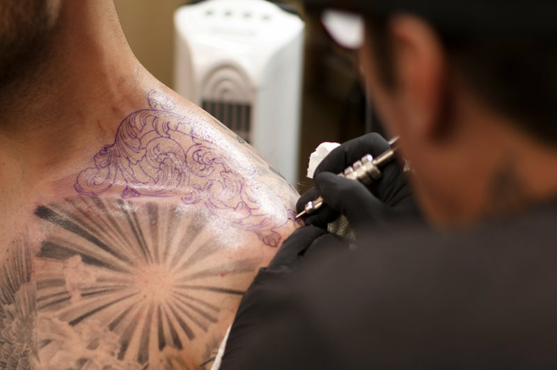 tattoo-img_2619_custom-ef0e1fd1fdc4619e992f31ec2020a8eb34ec031f-s800-c85.jpg Freddy Negrete, 61, works on a tattoo on a customer's shoulder.