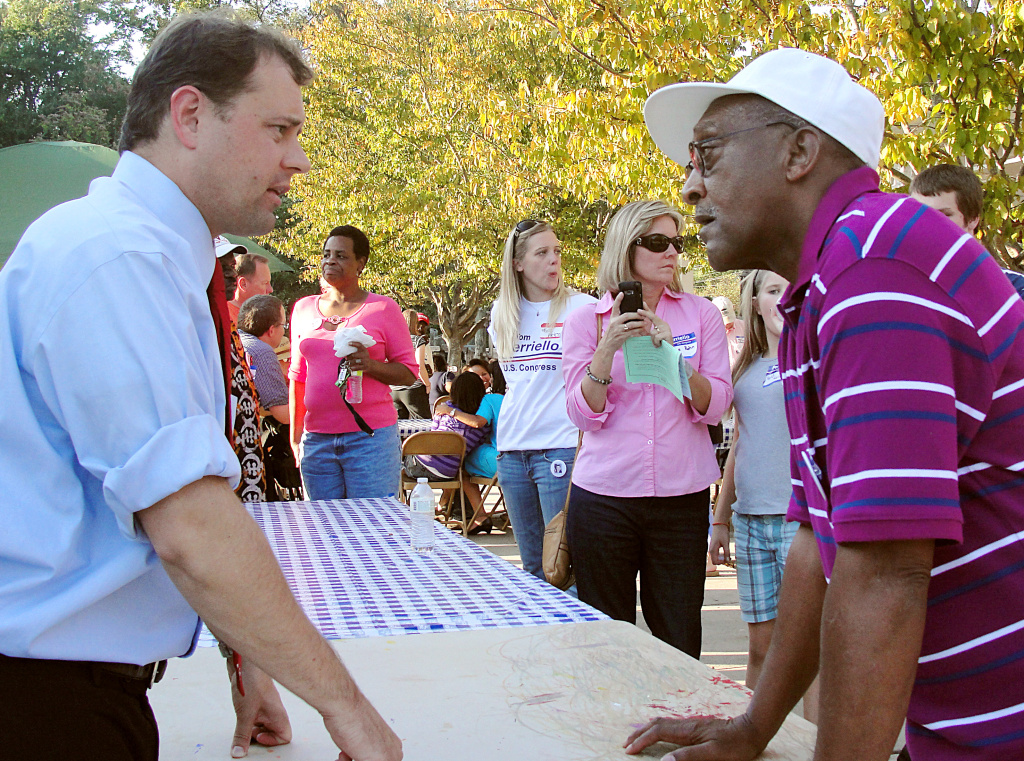 TO GO WITH AFP STORY US-VOTE-POLITICS-BL US Rep. Tom Perriello(L) D-VA, speaks to voter Charles Bailey during a campaign rally at Tonsler Park in Charlottesville, Virginia, on October 10, 2010.