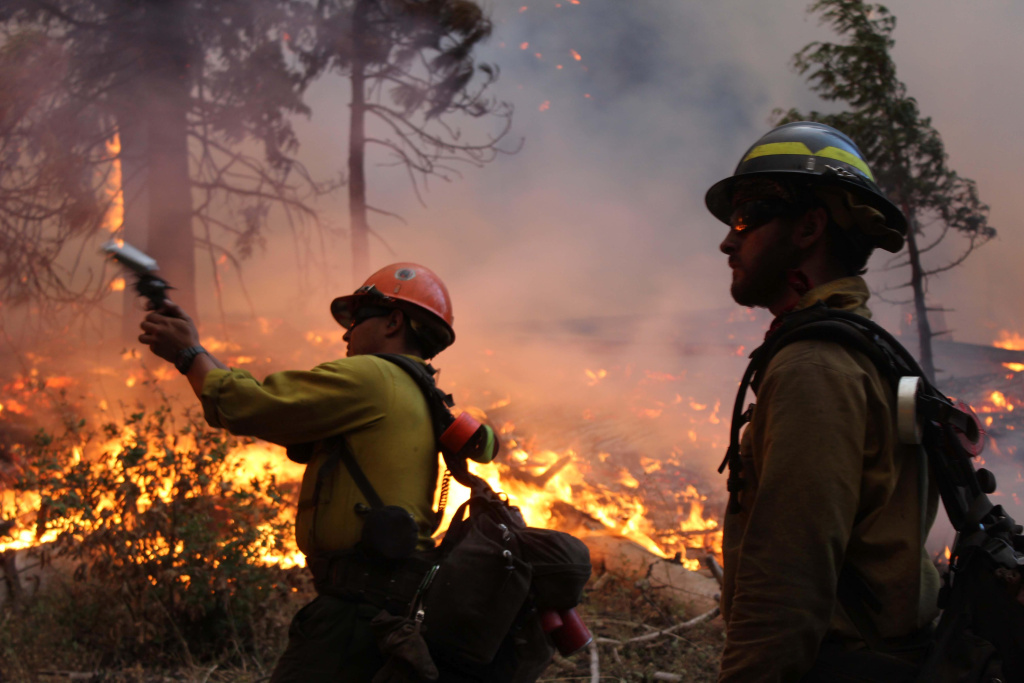 Western Wildfires Yosemite In this photo provided by the U.S. Forest Service, fire crew members stand watch near a controlled burn operation as they release a very pistol, as they fight the Rim Fire near Yosemite National Park in California, Monday, Sept. 2, 2013.