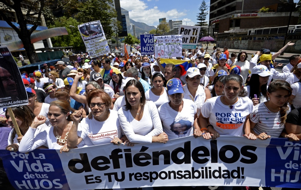 President Obama says new sanctions will target Venezuelan figures who have helped repress human rights. Here, opposition leader Maria Corina Machado, center, marched with opponents of President Nicolas Maduro in Caracas to mark International Women's Day. Here, opposition leader Maria Corina Machado, center, marched with opponents of President Nicolas Maduro in Caracas to mark International Women's Day. The crisis in the country hit new levels this week, with a new round of protests planned and Maduro extended a state of emergency.