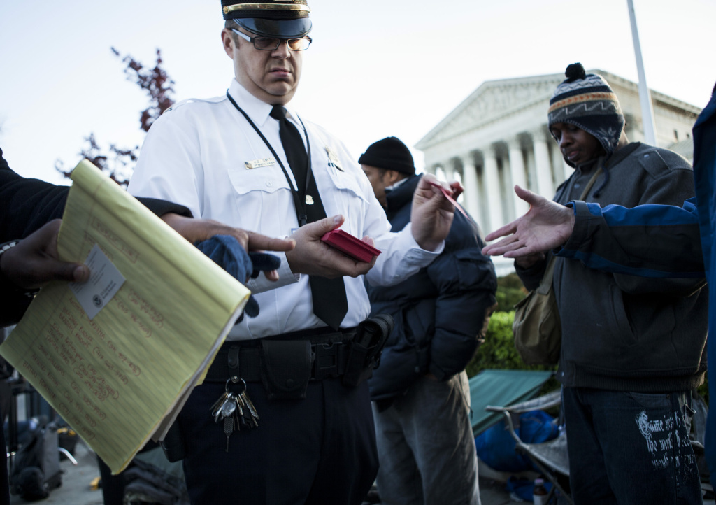 Supreme court weighs constitutionality of Obamacare A police officer hands out tickets to view court arguments outside the US Supreme Court on March 26, 2012 in Washington, DC. The Supreme Court will hear arguments challenging the Constitutionality of the Obama Administration's health care reforms during the first of three days of arguments .