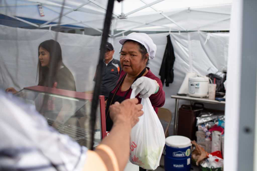 Customers buy Thai food from a stall at the East Hollywood Farmers Market, June 6, 2019. (James Bernal for KPCC)
Customers buy Thai food from a stall at the East Hollywood Farmers Market, June 6, 2019. (James Bernal for KPCC)