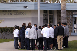 Students gather around a makeshift memorial at E.O. Green middle school, honoring slain school student Lawrence King, 15, who was killed by a classmate because he was gay, in this Feb. 14, 2008 file photo, in Oxnard, Calif.