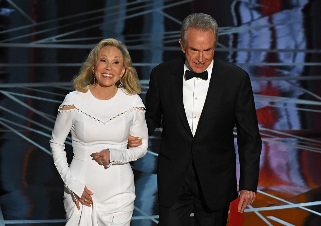 US-OSCARS-SHOW Actress Faye Dunaway and actor Warren Beatty arrive on stage to announce the winner of the Best Movie category at the 89th Oscars on February 26, 2017 in Hollywood, California.