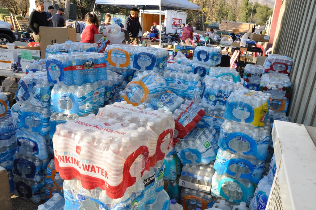 Upper Ojai Relief Station Thomas Fire Shoulder-high stacks of bottled water sit outside the Stagecoach Station convenience store in Upper Ojai. The store has become a community hub and host to an ad-hoc relief station neighbors established in the wake of the Thomas Fire.