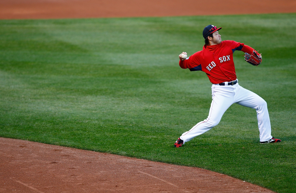 Boston Red Sox Workout Junichi Tazawa #36 of the Boston Red Sox warms up during the team workout at Fenway Park on October 29, 2013 in Boston, Massachusetts.