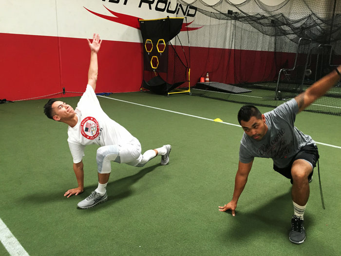 us badminton player Shu stretches with trainer Eliseo Cabildo in Corona, Calif. Shu, 25, started playing badminton as an 8-years-old.