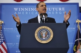 President Barack Obama gestures for the audience to take their seates as he arrives to speak on energy security for the country on March 30, 2011, at Georgetown University in Washington, D.C.