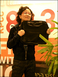 Mercer 7428 Off-Ramp producer Queena Kim strikes a pose with the coveted laptop bag.