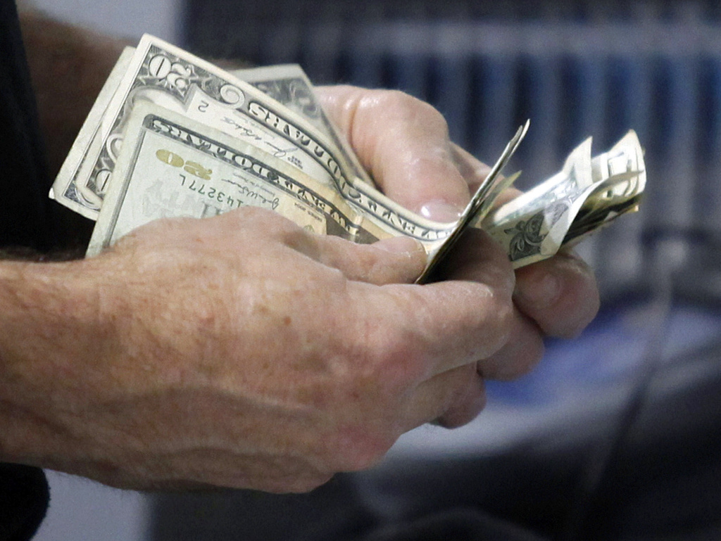 The U.S. economy grew at an annual rate of 1.8 percent in the first three months of the year, significantly slower than first thought. The Commerce Department said the steep revision was mostly because consumers spent less.
