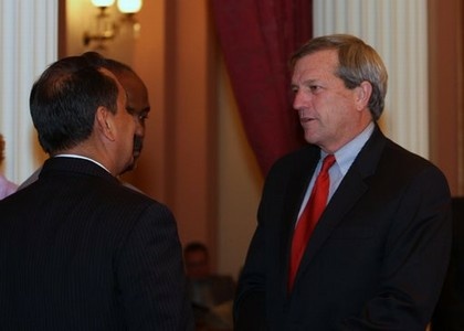 Sen. Mark DeSaulnier, D-Concord, discusses the budget revision package with colleagues during an all-night Senate session.