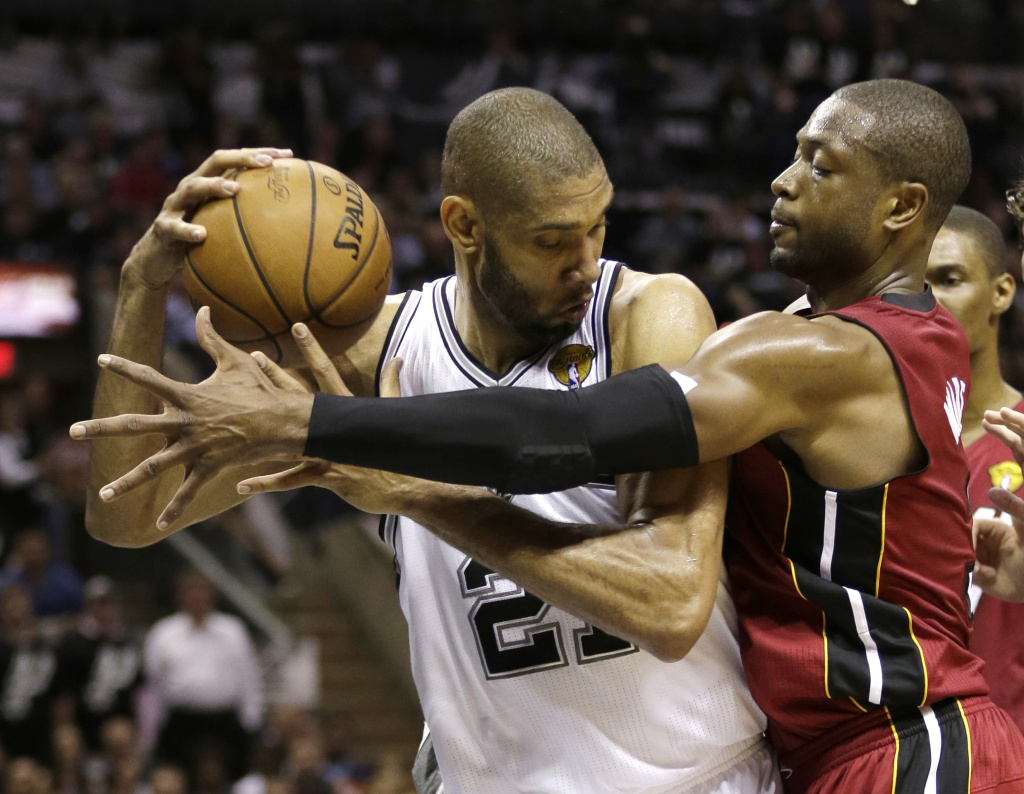NBA Finals Heat Spurs Basketball Miami Heat guard Dwyane Wade, right, defends against San Antonio Spurs forward Tim Duncan during the first half at Game 3 of the NBA Finals basketball series, Tuesday, June 11, 2013, in San Antonio.