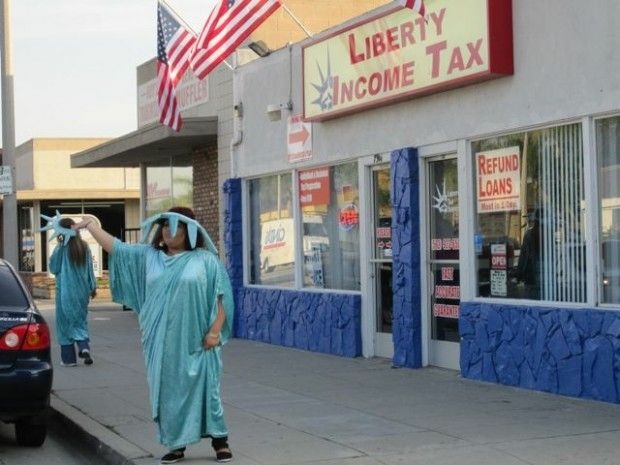 Nadine Subia, foreground, and Benita Romero wave at cars along Firestone Boulevard, January 7, 2010