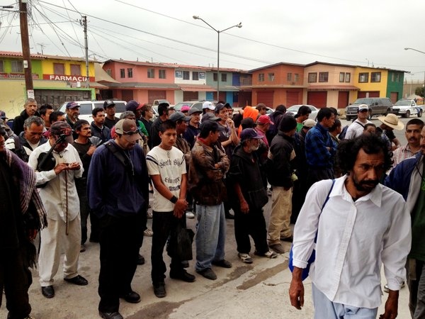 Tijuana Deportees form up outside a Tijuana breakfast hall, where many will have their only substantive meal of the day.