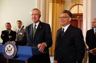 Senate Majority Leader Sen. Harry Reid (D-NV) (L) introduces Sen.-elect Al Franken (D-MN) before a meeting on Capitol Hill July 6, 2009 in Washington, DC. Al Franken will be officially sworn in as a U.S. Senator today after winning a court decision last month against Norm Coleman in his highly publicized Senate race.