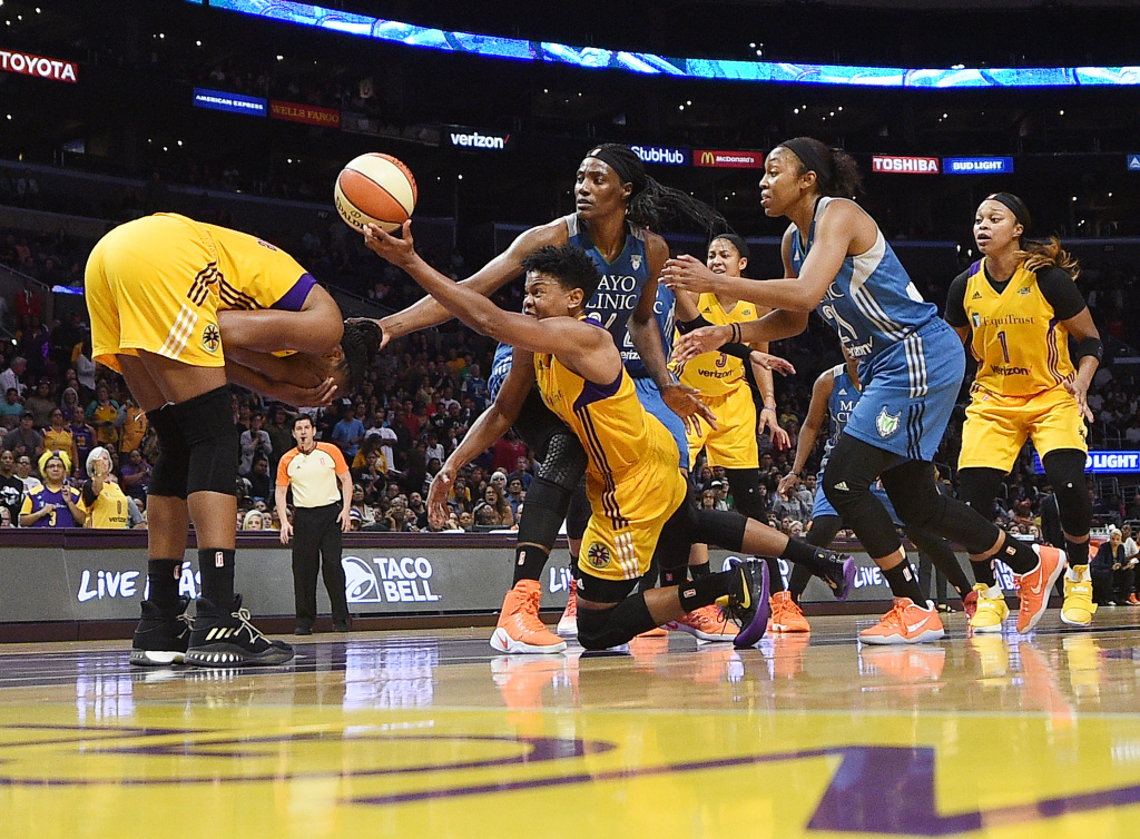 WNBA Finals - Game Three Alana Beard of the Los Angeles Sparks attempts to control the ball as teammate Nneka Ogwumike holds her face after an injury during the second half of Game Three of the 2017 WNBA Finals against the Minnesota Lynx.