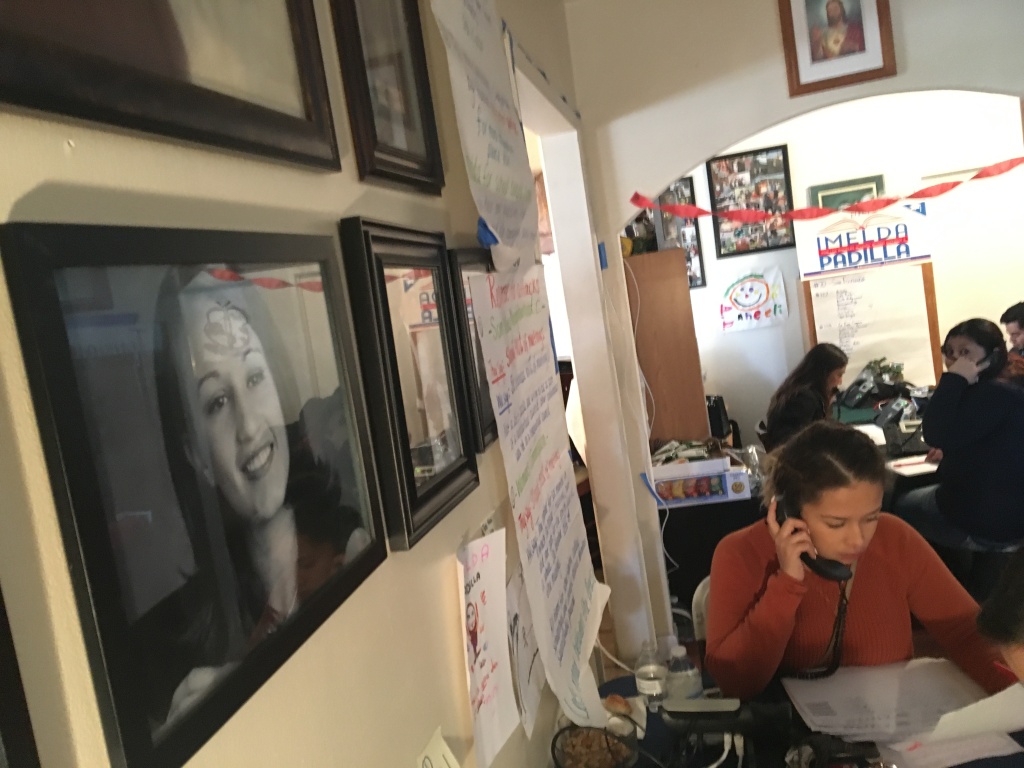 Carolina Salguero, bottom right, a volunteer for L.A. school board candidate Imelda Padilla, makes a campaign phone call in the campaign's headquarters in Padilla's childhood home in Pacoima. Family photos of the candidate, left, and her siblings cover the walls of the living room. Carolina Salguero, bottom right, a volunteer for L.A. school board candidate Imelda Padilla, makes a campaign phone call in the campaign's headquarters in Padilla's childhood home in Pacoima. Family photos of the candidate, left, and her siblings cover the walls of the living room.