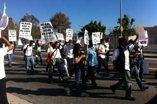 A group carrying signs with the slogan 'Black, gay & here to stay. We are your family' march in the 26th annual King Day Parade in South Los Angeles.