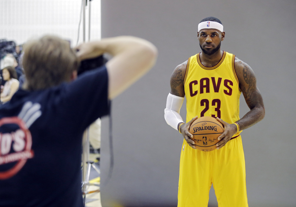 LeBrons League Basketball In this Sept. 26, 2014 photo, Cleveland Cavaliers' LeBron James poses for Sports Illustrated photographer Al Tielemans during the NBA basketball team's media day in Independence, Ohio. With an undeniable hold on the NBA, James rules the league. He sets the tone on and off the floor. But beyond being the undisputed best all-around player, James, who re-signed with the Cavaliers this summer, has become a one-man business conglomerate. (AP Photo/Mark Duncan)