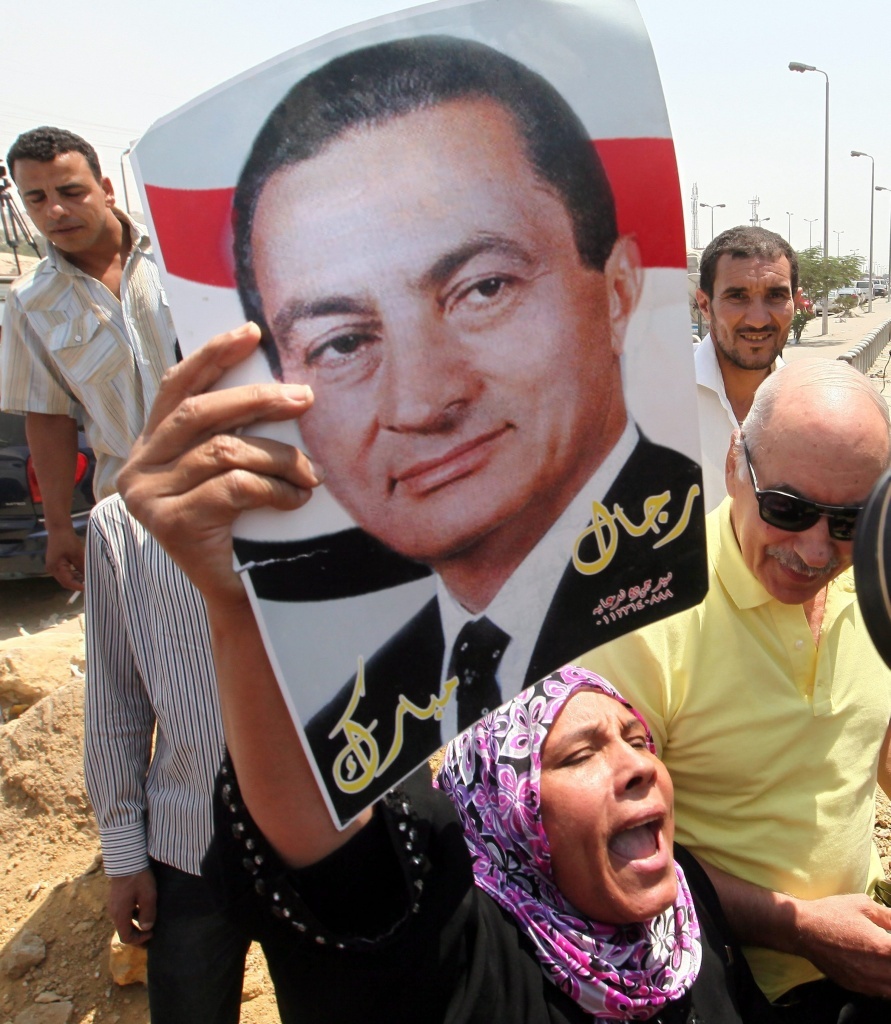 A supporter of former Egyptian President Hosni Mubarak celebrates his release from prison on Thursday. He's still under house arrest while awaiting retrial on various charges.