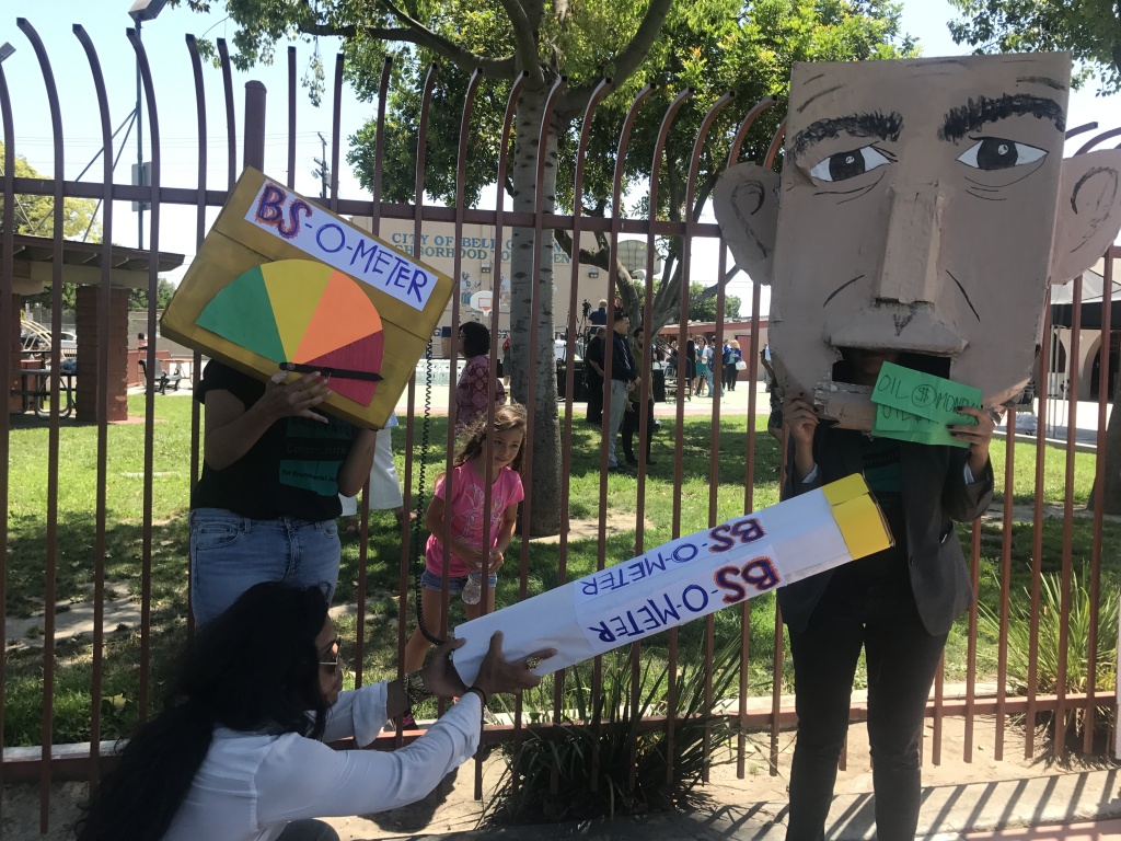 Environmental activists from the East Yards Communities for Environmental Justice pose with signs and protest materials depicting Governor Jerry Brown. Environmental activists from the East Yards Communities for Environmental Justice pose with signs and protest materials depicting Governor Jerry Brown.