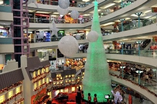Mercer 13154 People shop in a shopping mall decorated with a giant Christmas tree made of 59,327 mineral water bottles. Consumers spent and earned more in November, reflecting a rebound from the disruptions caused by Superstorm Sandy. The Commerce Department says consumer spending rose 0.4 percent compared with October. Personal income jumped 0.6 percent, the biggest gain in 11 months.