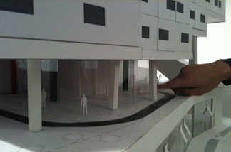 Silver Lake architect Michael Maltzan shows the scale of a model for a new sustainable building.