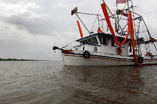 An oil skimming boat returns to port after inclement weather forced them to abandoned the effort to clean up oil from the Deepwater Horizon oil spill in the Gulf of Mexico on July 2, 2010 in Terrebonne Bay, Louisiana.