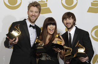 Lady Antebellum, from left, Charles Kelley, Hillary Scott and Dave Haywood pose backstage with the award for best record of the year at the 53rd annual Grammy Awards on Sunday, Feb. 13, 2011, in Los Angeles.