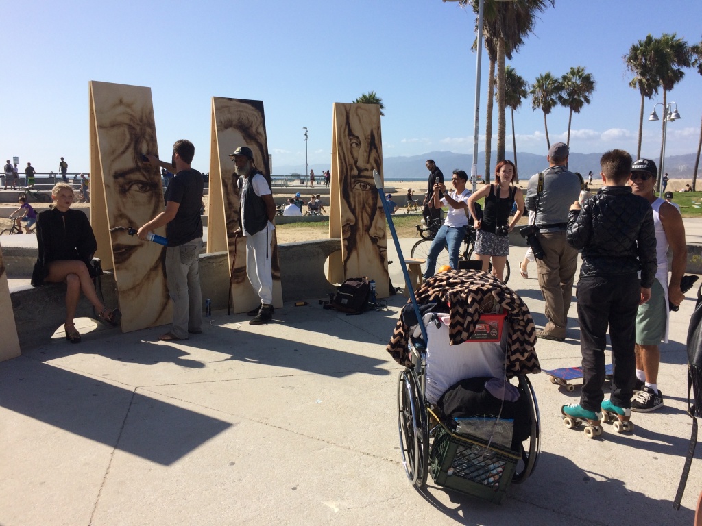 A crowd gathers on the Venice Boardwalk to watch Aronson paint. He regularly works at art walks and other live outdoor events around Los Angeles. A crowd gathers on the Venice Boardwalk to watch Aronson paint. He regularly works at art walks and other live outdoor events around Los Angeles.