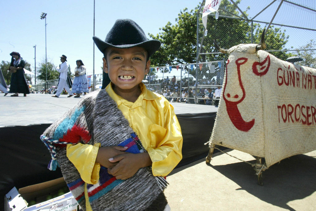 A boy wearing a traditional Oaxcan costu A child in traditional Oaxacan costume participates in a Guelaguetza festival in Los Angeles. The U.S. Census has begun to note that many Latinos in this country identify more by their indigenous groupings than by their countries or origin.