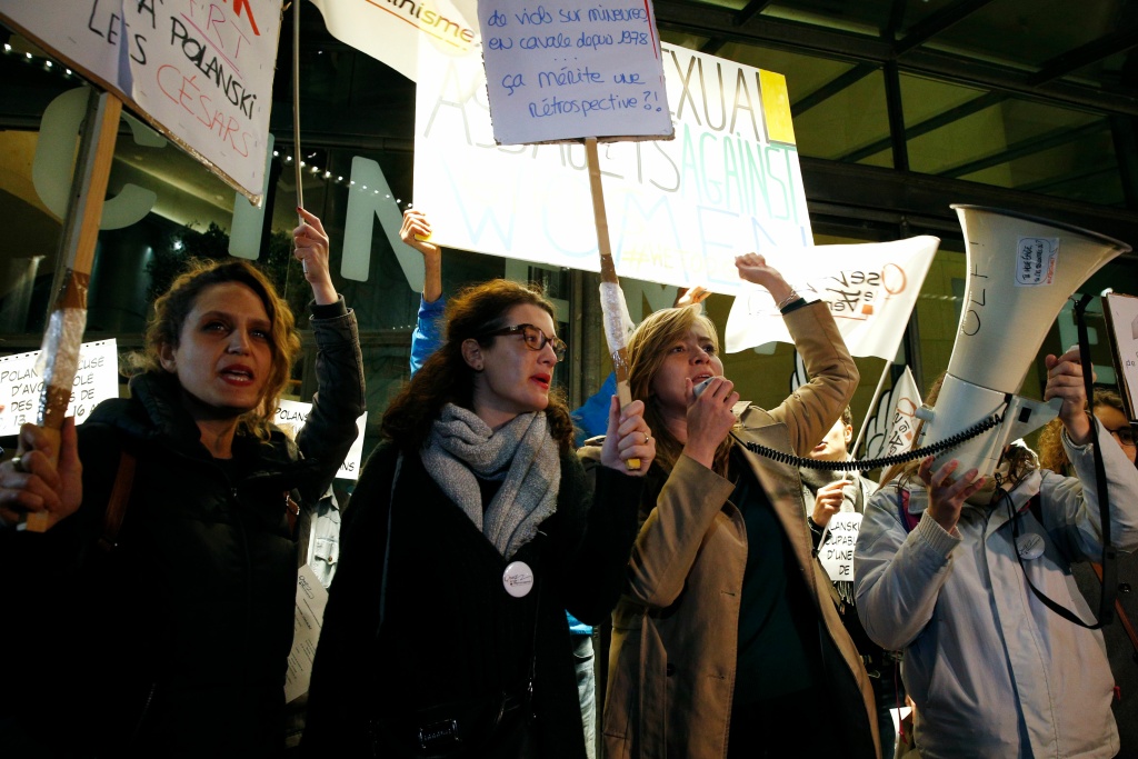 FRANCE-WOMEN-CINEMA-POLANSKI-PROTEST Protesters hold placards during a demonstration on October 30, 2017, outside the Cinematheque Francaise film archive in Paris, where filmmaker Roman Polanski, accused of a string of sexual assaults, is expected to attend a retrospective of his work.