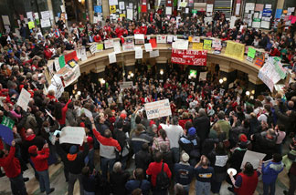 Protestors demonstrate in the rotunda of the state capitol on February 24, 2011 in Madison, Wisconsin.