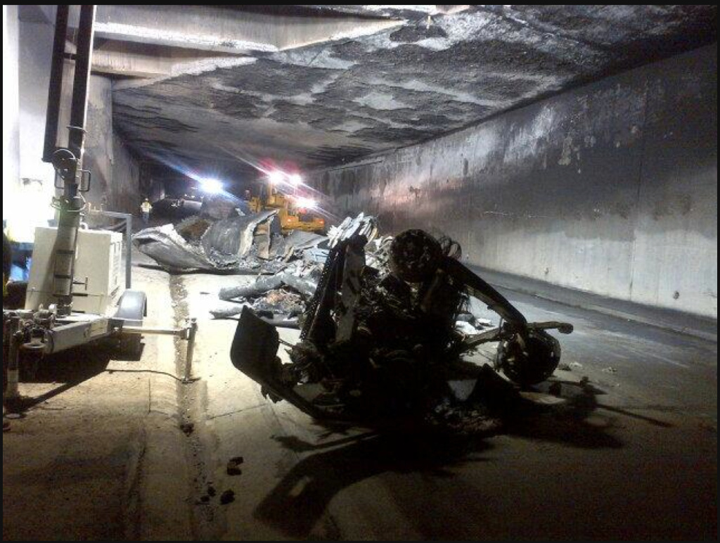 File: The inside of the tunnel shows damage to the structure and what's left of the burned out gasoline tanker truck.