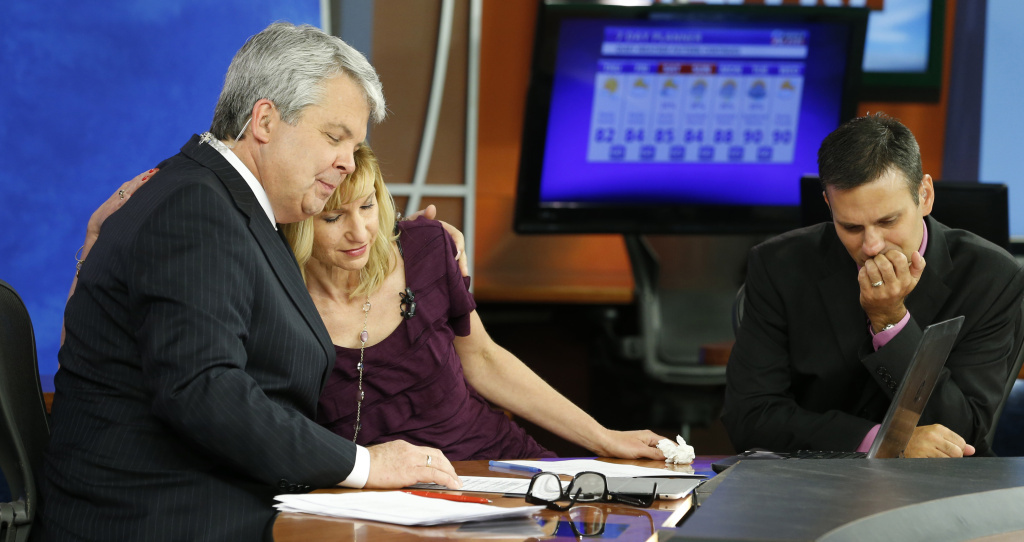 WDBJ-TV news morning anchor Kimberly McBroom, center, gets a hug from visiting anchor Steve Grant, left, as meteorologist Leo Hirsbrunner reflects after their early morning newscast at the station on Thursday. WDBJ-TV news morning anchor Kimberly McBroom, center, gets a hug from visiting anchor Steve Grant, left, as meteorologist Leo Hirsbrunner reflects after their early morning newscast at the station on Thursday.