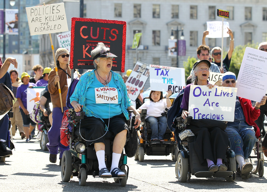 Bay Area Activists Protest Cuts To Medicaid SAN FRANCISCO, CA - SEPTEMBER 21: Disabled people carry signs as they protest cuts to Medical and Medicare on September 21, 2011 in San Francisco, California.