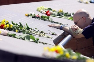 Mercer 15487 James Dann of Thornton, Colorado pauses at one of the names of the victims of the Columbine High School shootings on the ten-year anniversary at the Columbine Memorial Park April 20, 2009 in Littleton, Colorado.